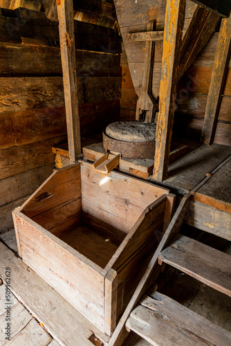 Ancient mill made of stones and wood. Weet grinding machine used in making Flour