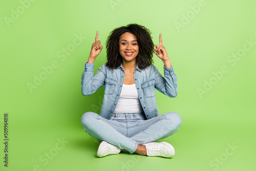 Full body photo of young lady indicate fingers empty space promo select banner isolated over green color background