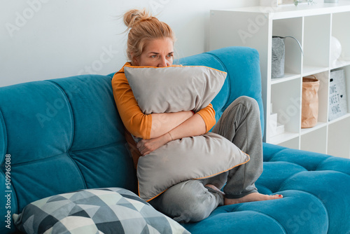 Obraz na plátně Unhappy lonely depressed woman home, she sitting couch hiding her face pillow, d