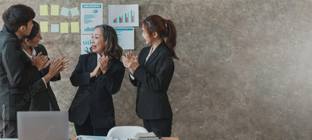 Fototapeta premium A highly qualified senior businesswoman and her staff cheered in meetings, planning meetings and training sessions to discuss internal issues. Management concepts of senior executives.