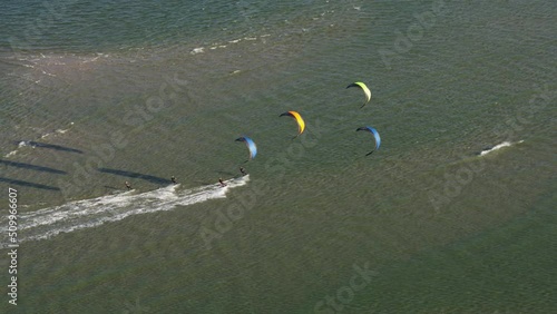 People kitesurfing on windy day on Netherlands coastline, aerial view