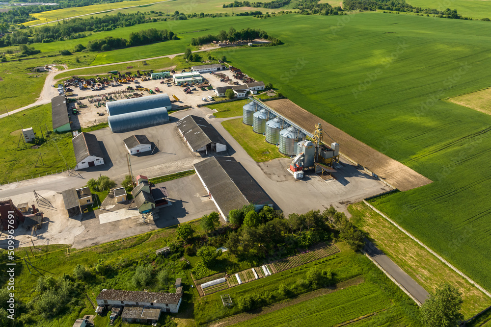aerial view on agro silos granary elevator on agro-processing manufacturing plant for processing drying cleaning and storage of agricultural products, flour, cereals and grain.