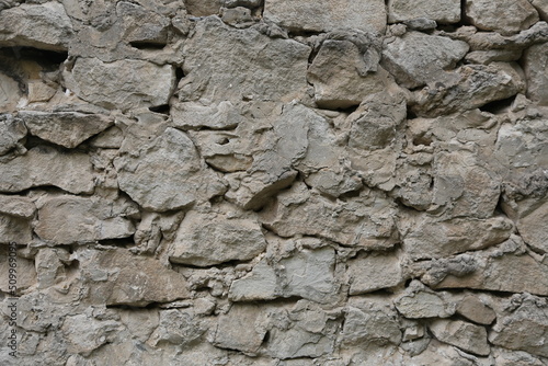 old wall made of light stone. background texture