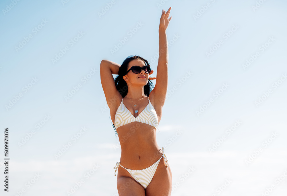 people, summer and swimwear concept - happy smiling young woman in bikini swimsuit on beach people, summer and swimwear concept - happy smiling young woman in bikini swimsuit on beach