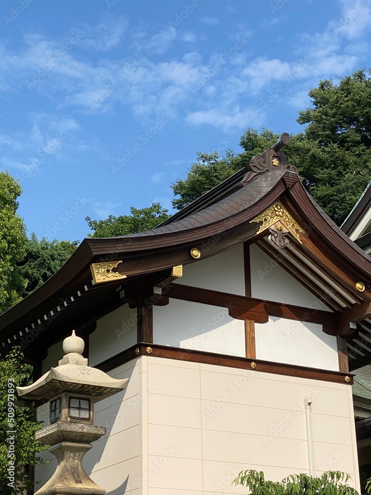 The rooftop gold emblem decor of ancient Japanese shrine house, Ueno park Gojyoten Jinjya” temple, year 2022 sunny weekday 