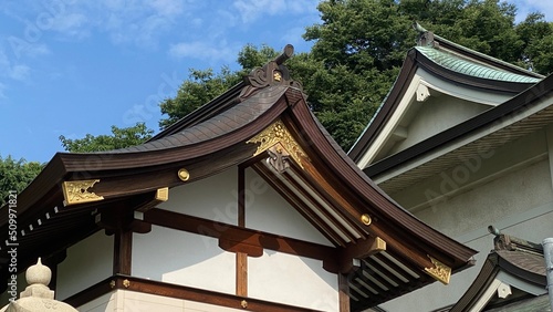 The rooftop gold emblem decor of ancient Japanese shrine house, Ueno park Gojyoten Jinjya” temple, year 2022 sunny weekday 