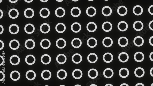 Abstract monochrome continuously moving pattern of simple geometric shapes. Looped animation. Digital background