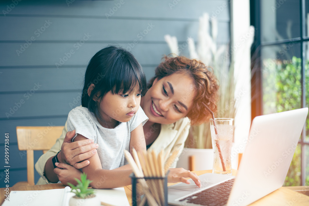 Family time, mom and girl enjoy learning on internet, helping kid study from home, work from home, having breakfast Family time, mom and girl enjoy learning on internet, helping kid study from home, work from home, having breakfast