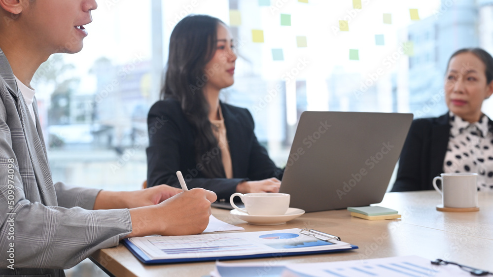 Focused young employees are meeting for marketing strategy at modern office Focused young employees are meeting for marketing strategy at modern office