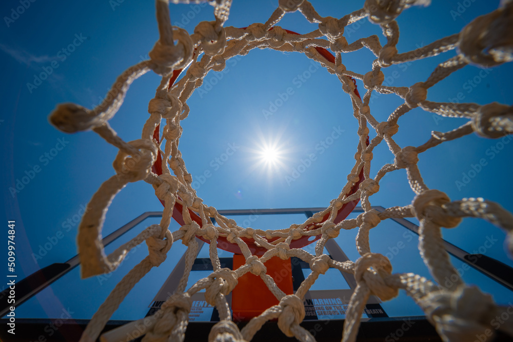 Outdoor basketball court. Street basketball board with the blue sky