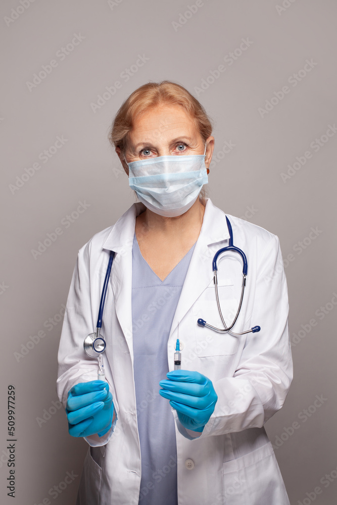 Doctor in medical mask ready to make injection