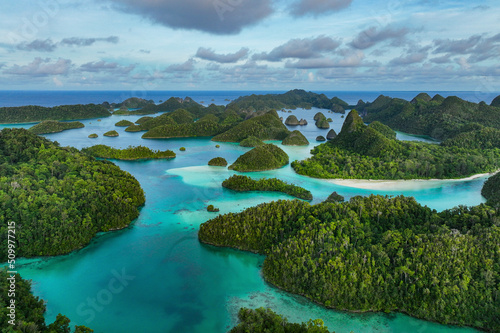 Aerial view of scattered islands with blue ocean water at Wajag Island, Raja Ampat, West Papua, Indonesia. photo