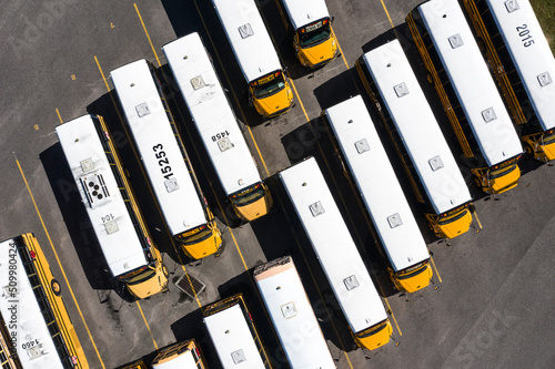 Palm Bay, USA - 27 March 2021: Aerial view of school buses parked in a parking lot, Palm Bay, Florida, United States.