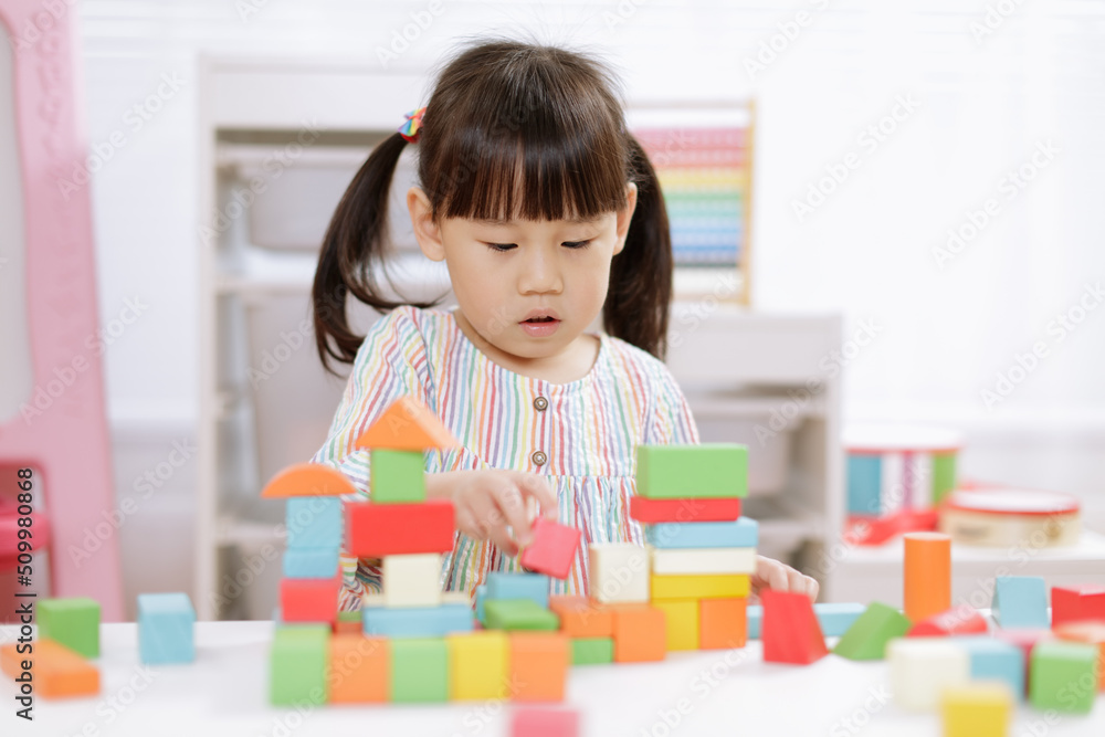 young girl playing creative toy blocks for homeschooling young girl playing creative toy blocks for homeschooling