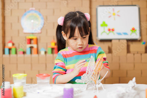 young girl hand make craft for home schooling