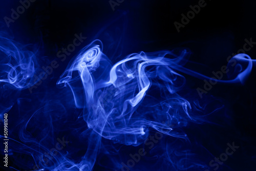 Blue smoke on a black background.
