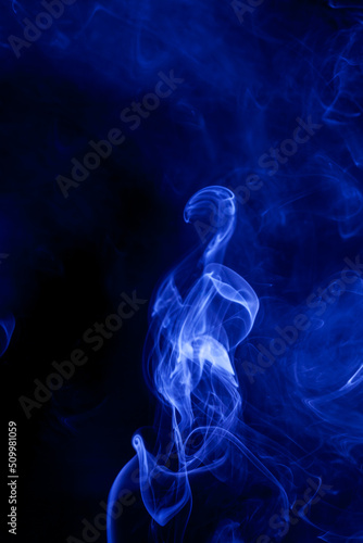 Blue smoke on a black background.