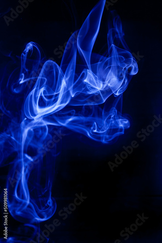 Blue smoke on a black background.
