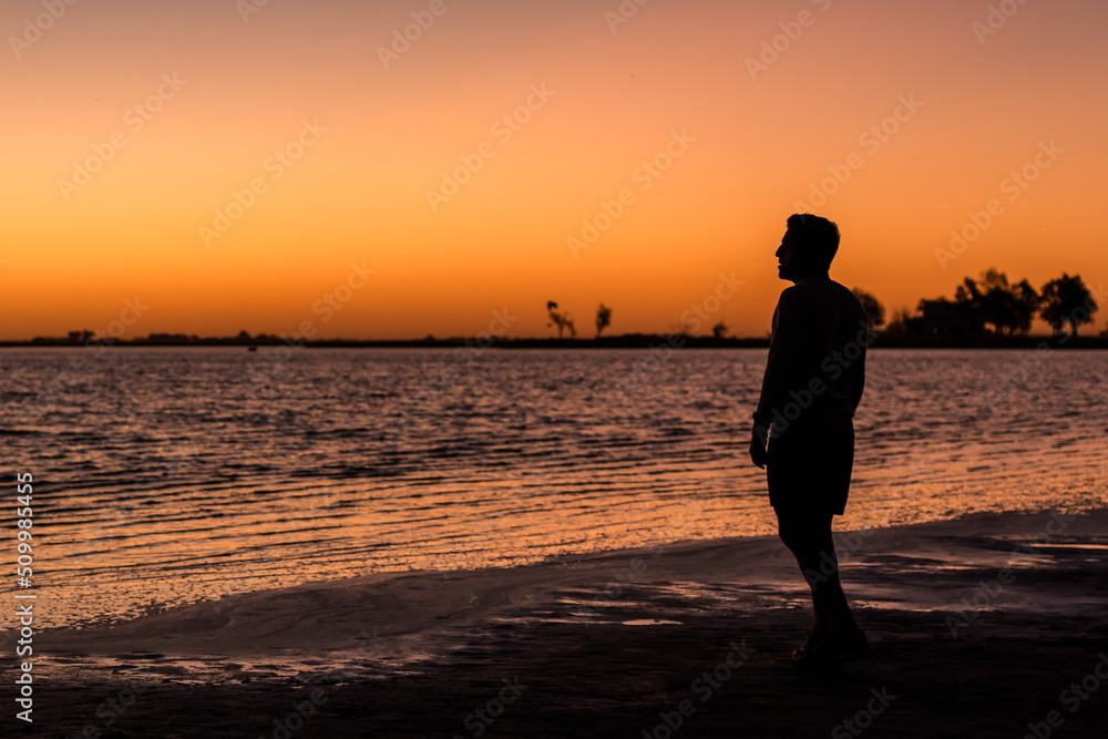 Young man looking at one of the most amazing sunsets ever seen. Space for text. Life style concept