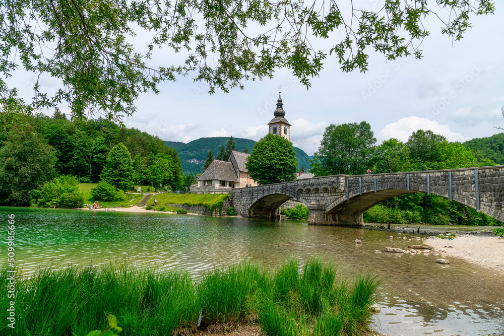 Bohinj Lake, Church of St John the Baptist with bridge. Triglav National Park, Julian Alps, Slovenia. Bohinj Lake, Church of St John the Baptist with bridge. Triglav National Park, Julian Alps, Slovenia.
