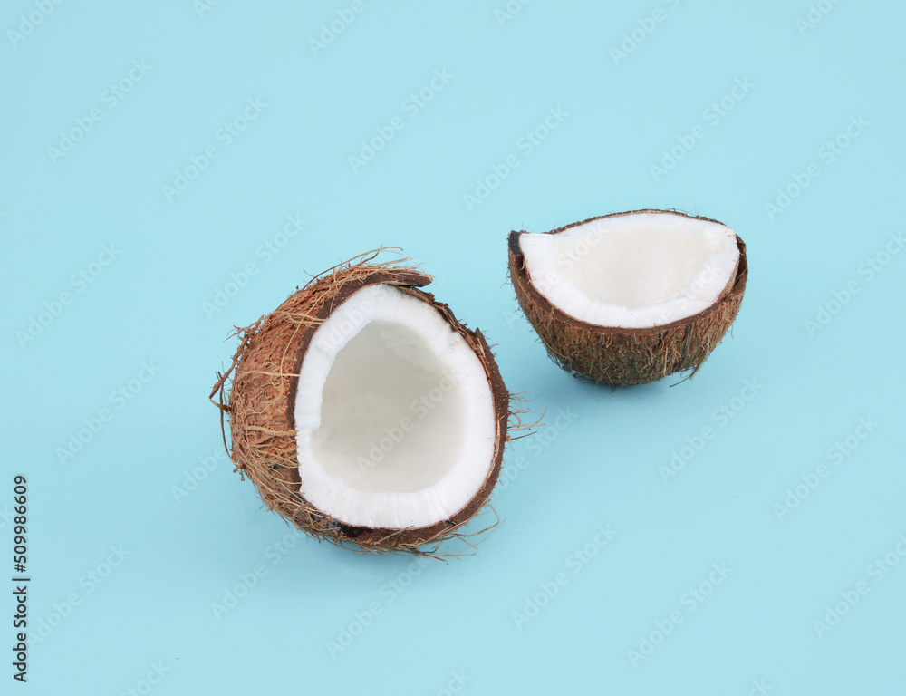 split coconut on blue background split coconut on blue background