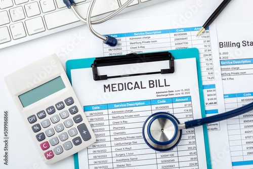 Medical bill with calculator and stethoscope on white desk