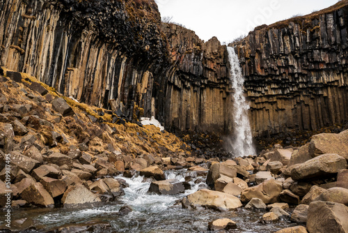 The famous Svartifoss waterfall, fed from Stórilækur river, in its basalt column gorge in Skaftafell nature preserve, Vatnajökull National Park, Iceland, next to Route 1 / Ring Road