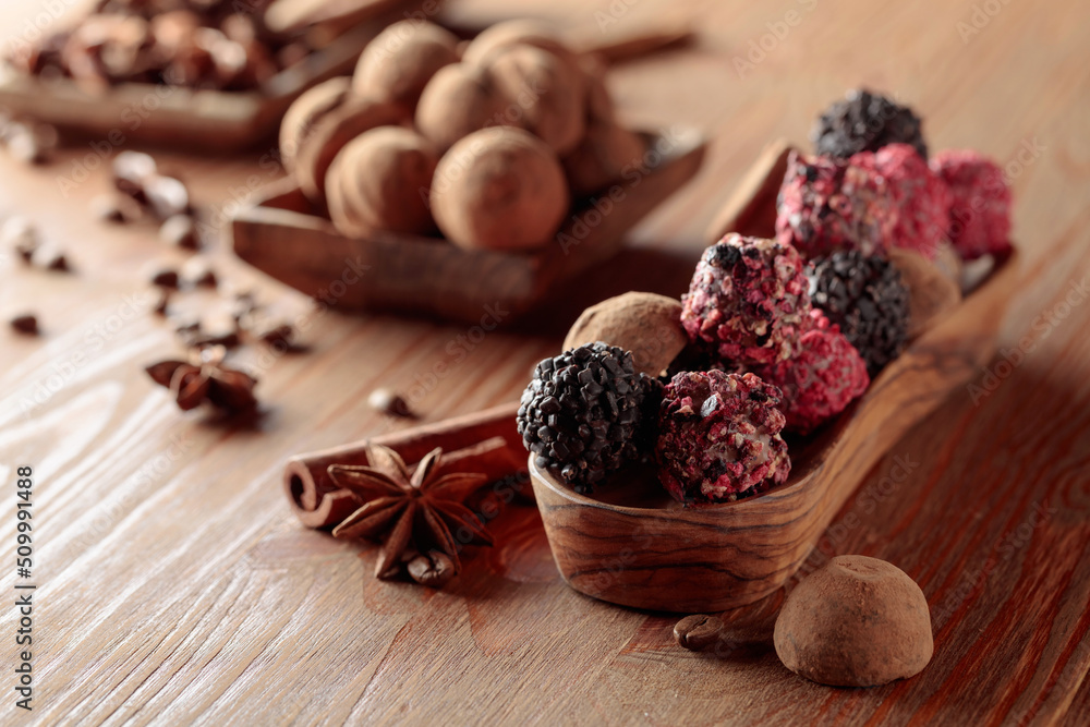 Chocolate truffles on a wooden table.