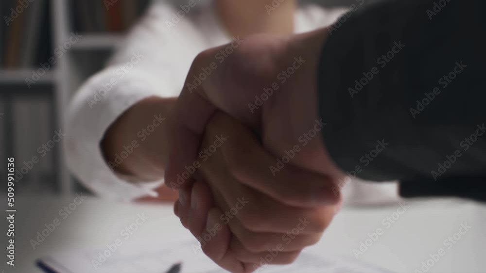 Closeup handshake, insurance agent girl shaking hands with client ...