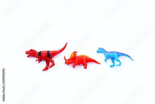 Plastic dinosaur toys on white background. Top view © Bowonpat