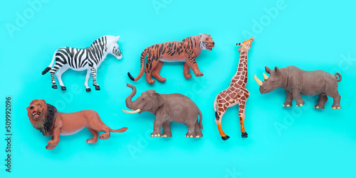 Fototapeta Naklejka Na Ścianę i Meble -  Plastic jungle animal toys on blue background.