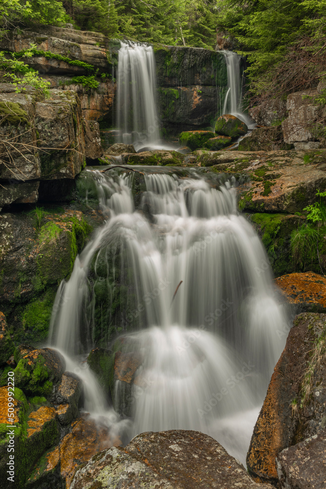 Fototapeta premium Waterfall of Jedlova creek in Jizerske mountains in spring morning