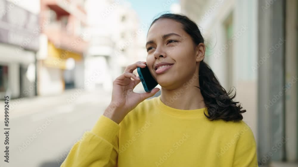 Young african american woman smiling confident talking on the smartphone at street Young african american woman smiling confident talking on the smartphone at street