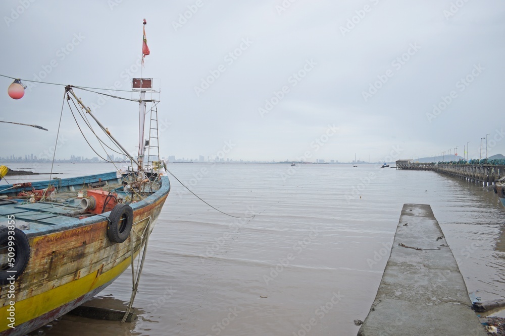 Fototapeta premium Old Wooden Half-Ruined Ship Moored On A Fishing Dock