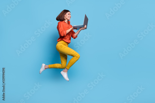 Full size profile side photo of young girl look laptop manager representative meeting distance isolated over blue color background