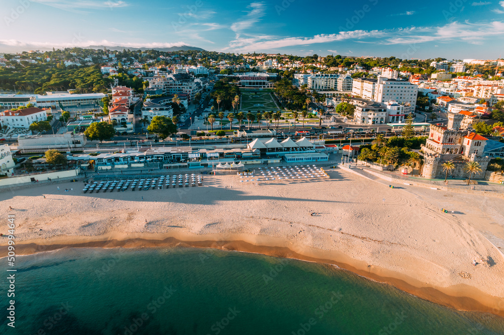 Estoril, Portugal - June 9, 2022: Aerial view of Tamariz Beach with Casino Estoril in the end of the garden and Hotel Palacio on the right