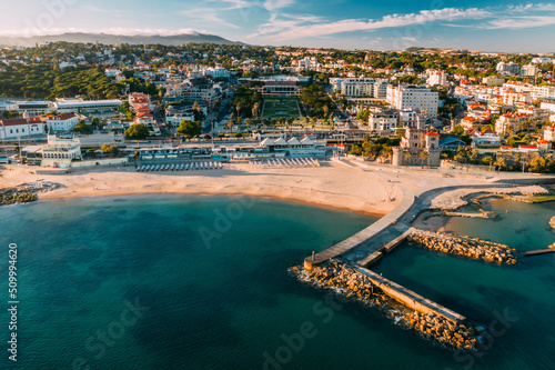 Estoril, Portugal - June 9, 2022: Aerial view of Tamariz Beach with Casino Estoril in the end of the garden and Hotel Palacio on the right © Alexandre Rotenberg