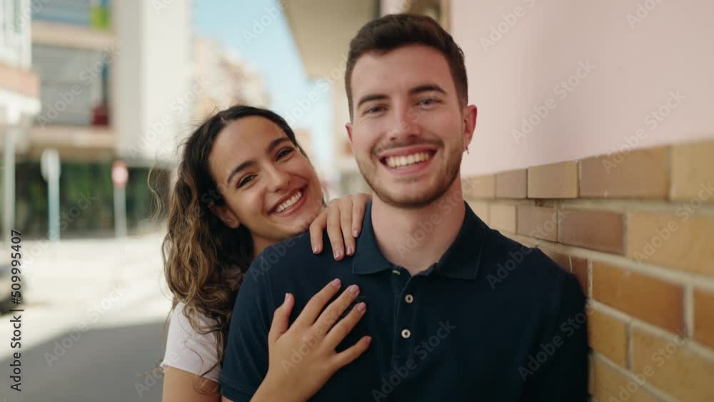 Young hispanic couple smiling confident hugging each other at street Young hispanic couple smiling confident hugging each other at street