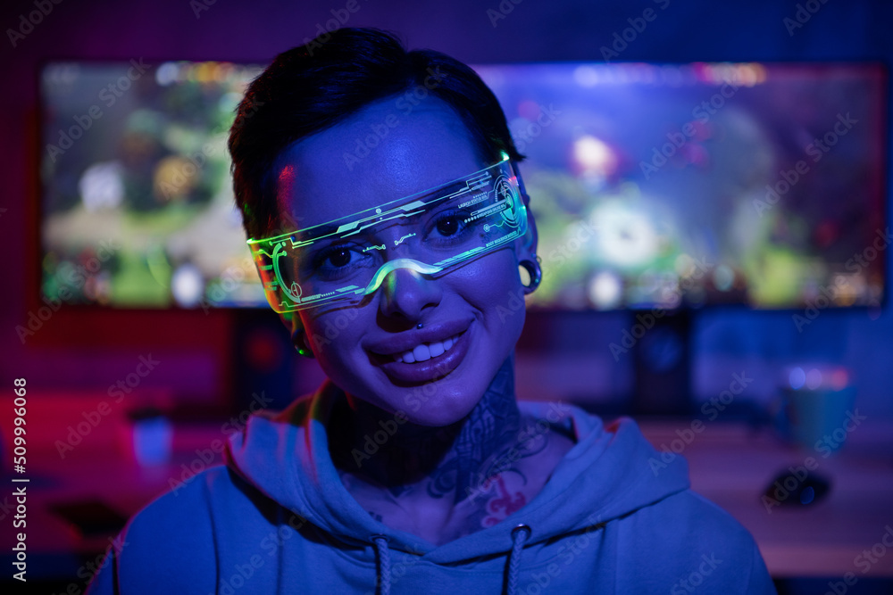 Portrait of positive hipster gamer girl vr glasses toothy smile have good mood dark room computer club indoors Portrait of positive hipster gamer girl vr glasses toothy smile have good mood dark room computer club indoors