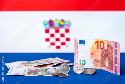 Croatian currency, kuna, together with Euro coins and 10 Euro banknote. Croatia adopted a European currency theme with the Croatian flag motif in the background. photo