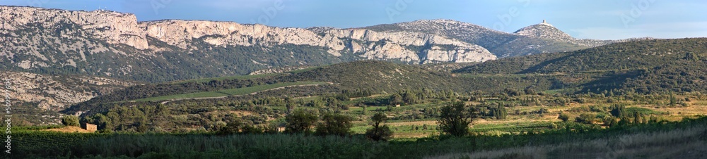 Panoramic view of a mountain landscape near Tuchan with the medieval Tour de Far tower in the background, Occitanie region in France
