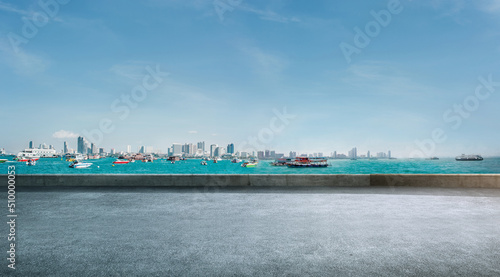 Empty paved roads and city skyline
