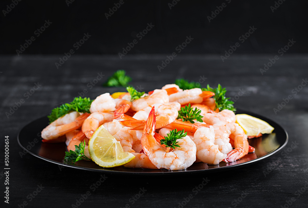 Shrimps, prawns on black plate. Boiled shrimps, prawns. Seafood. Shrimps, prawns on black plate. Boiled shrimps, prawns. Seafood.
