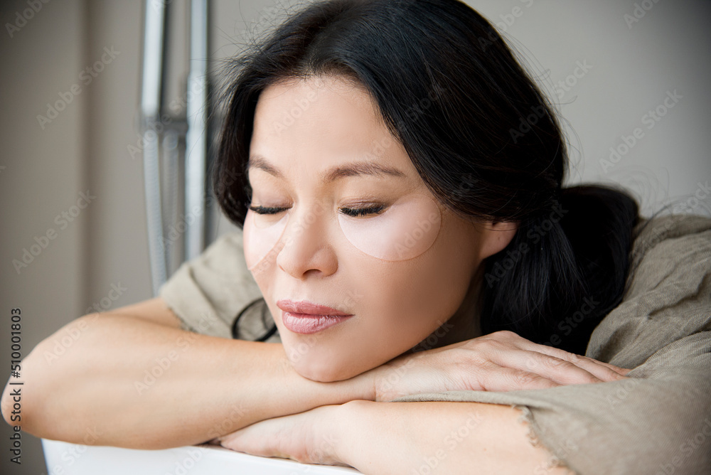 portrait of asian beautiful woman with transparent patch under eye relaxing with close eyes in spa salon portrait of asian beautiful woman with transparent patch under eye relaxing with close eyes in spa salon