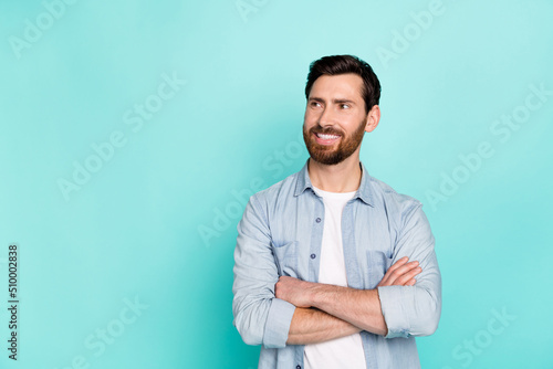 Photo of minded clever person folded hands look interested empty space isolated on teal color background
