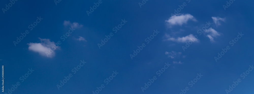Fototapeta premium Blue sky with a few clouds background.