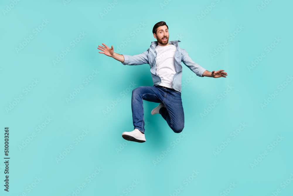 Full body photo of satisfied sportive person jumping enjoy free time isolated on teal color background