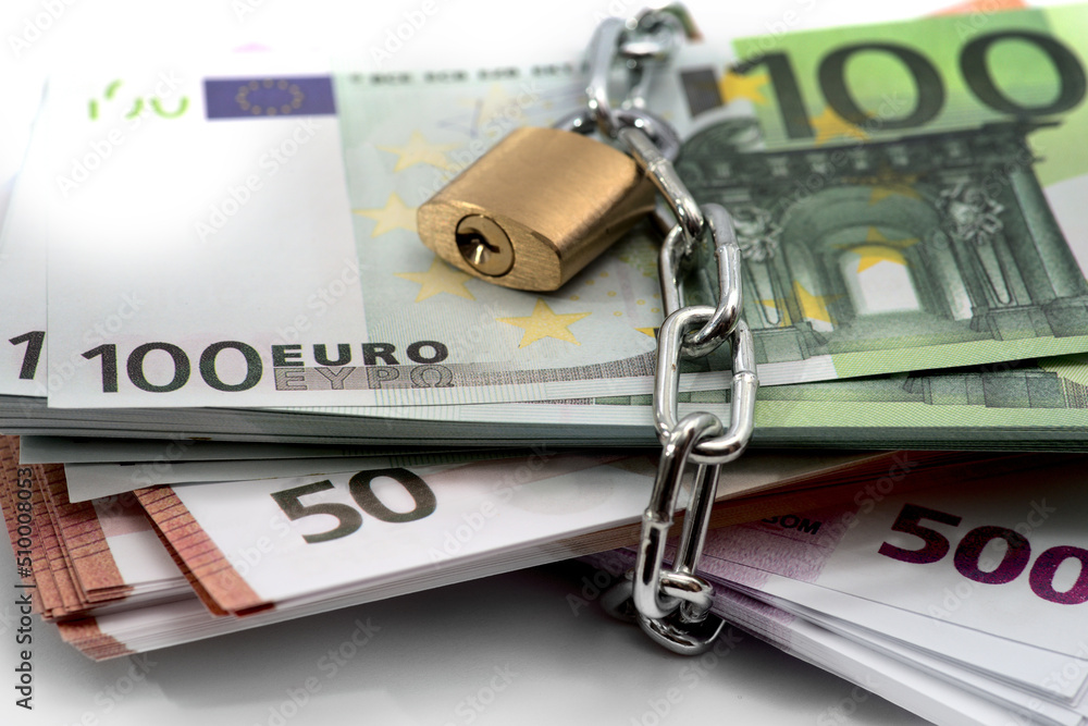 Bundle of euro bill, lock, chain, EU flag. Concept with European Union money, cash, loans, mortgage Bundle of euro bill, lock, chain, EU flag. Concept with European Union money, cash, loans, mortgage