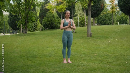 The woman stands on the nails. Close-up of human feet on sadhu board.