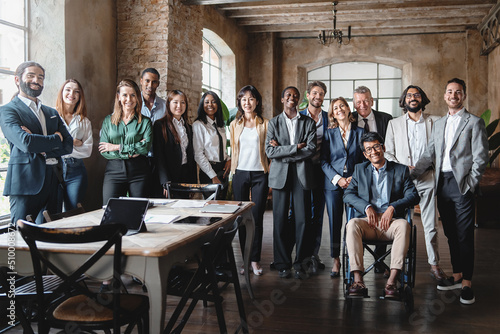Vászonkép Corporate portrait of a multigenerational working team with multiracial and disabled members - Group photo of colleagues standing in the office in co-working space - business lifestyle concept